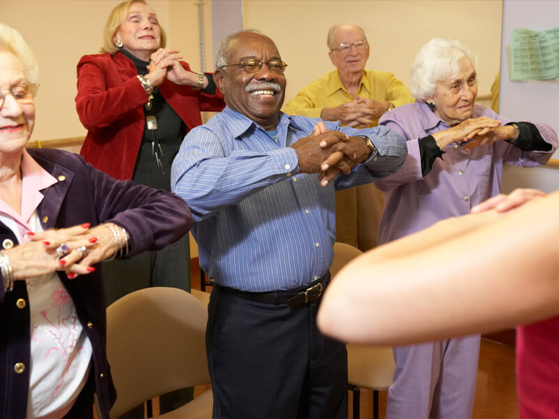 seniors practicing stretching techniques during a healthy aging event